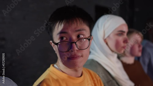 Asian guy looks away and be together with friends