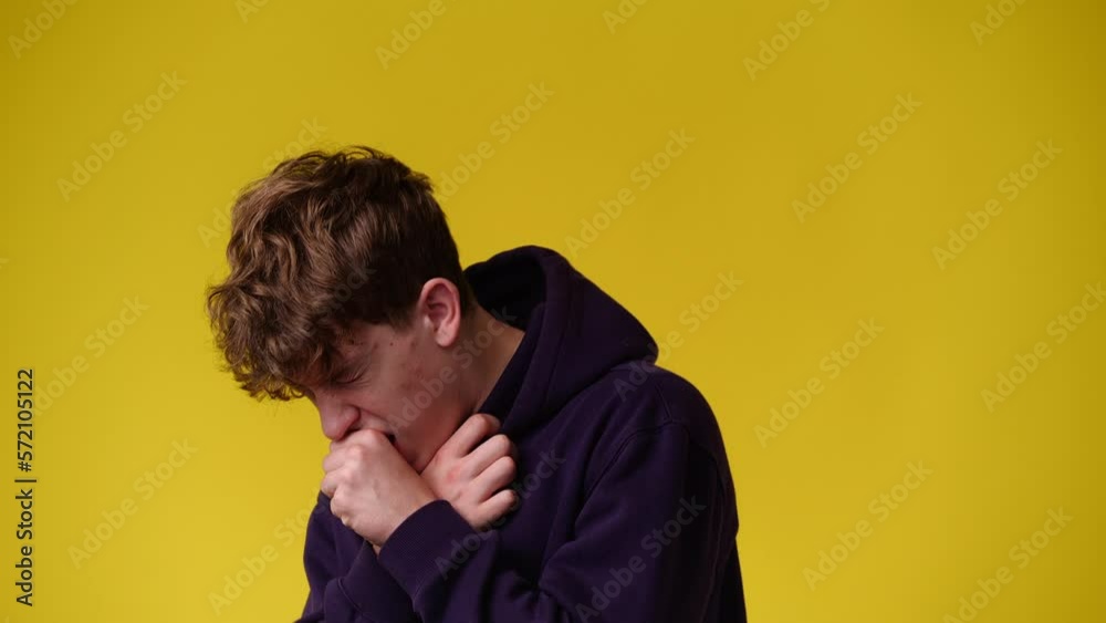 4k video of one man coughing and clutching his chest over yellow background. 4k video of one man coughing and clutching his chest over yellow background.