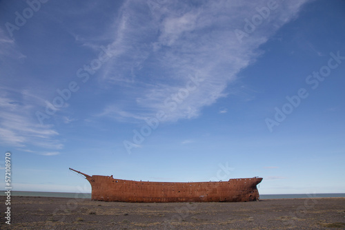 Rusty hull of the old British ship Marjory Glenn burned down in 1911. It lies today on the shores of Punta Loyola in Argentine Patagonia photo
