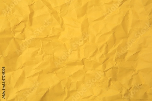 Sheet of crumpled orange paper as background, top view