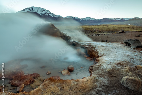 Geysers El Tatio with river and volcanic landscape at sunrise, Atacama, Chile