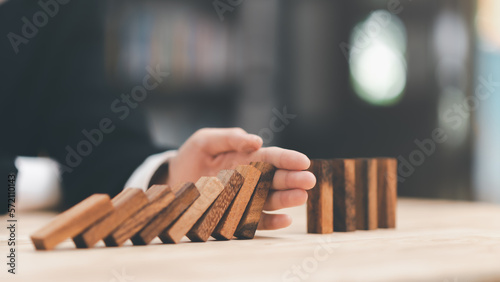 protection and risk management, Financial risk management ,Business Investment Feasibility Assessment, protection of business interests, Human hands blocking wooden sticks,