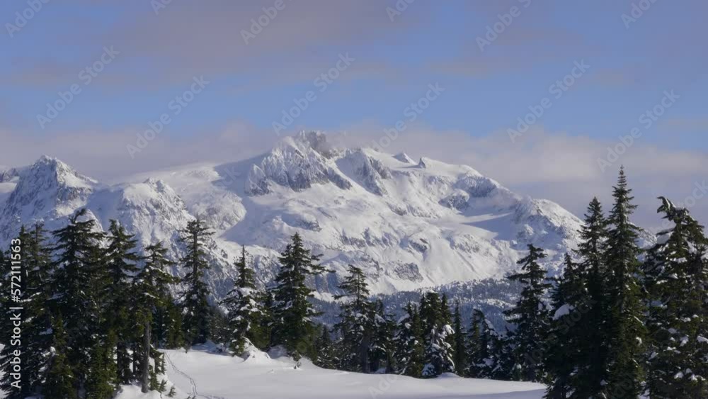 Snow-Covered Massif Rock Mountains With Conifer Trees During Winter. Static Shot Snow-Covered Massif Rock Mountains With Conifer Trees During Winter. Static Shot