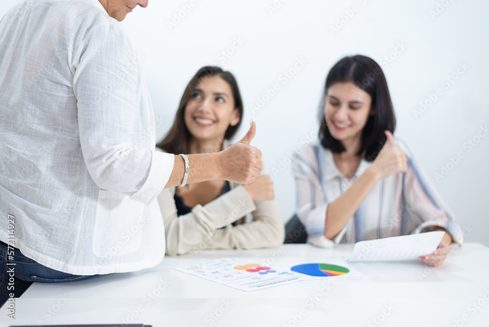 Businesswoman showing thumbs up and working in office.,Successful and teamwork concept Businesswoman showing thumbs up and working in office.,Successful and teamwork concept