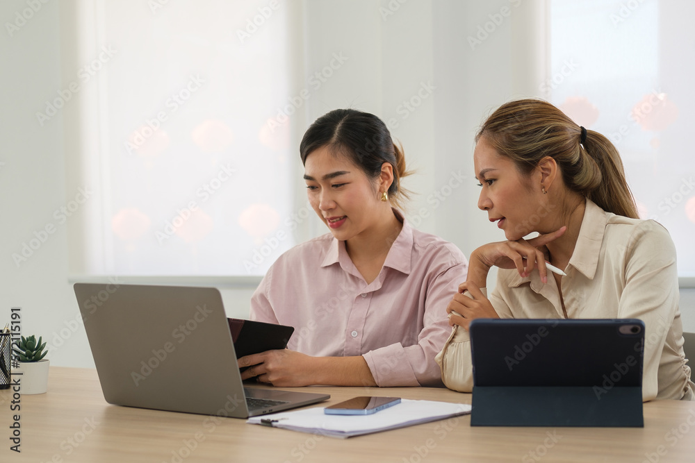 Shot of two young workers looking at laptop screen working on a project of company. Shot of two young workers looking at laptop screen working on a project of company.