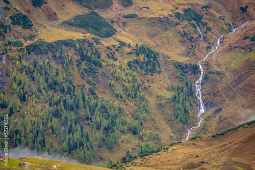 Obraz na płótnie Hohe Tauern pine woodland and waterfall from above Grossglockner road at dawn, Austria w salonie