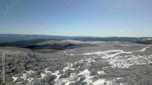 Aerial shot over a snowy mountain top in Manzaneda, Galicia. photo