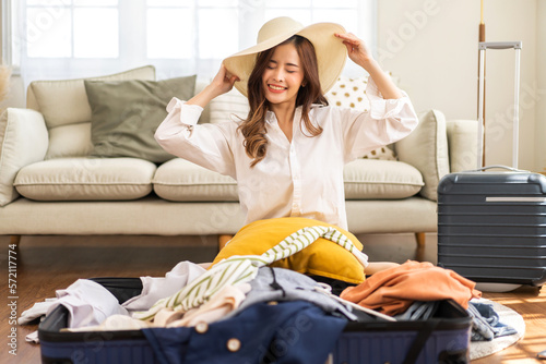 Portrait of beauty asian traveler woman packing stuff and outfit clothes in suitcases travel bag luggage for summer holiday weekend tourist vacation trip at home. travel concept