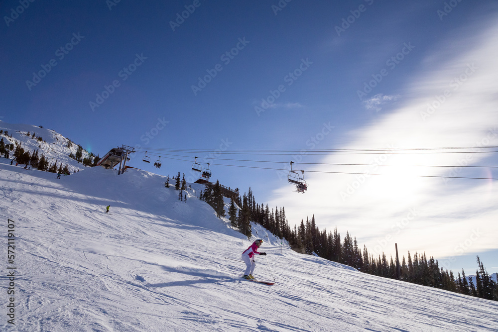 Mountain peak and chair lift with skiers, winter landscape, ski resort, Whistler BC.