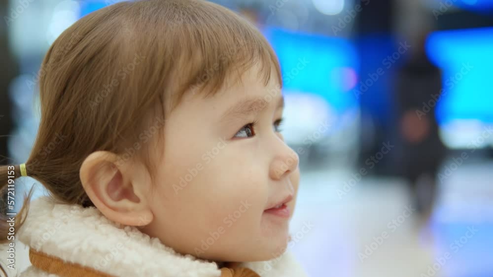 Happy 3-Year-Old Girl Enjoying Playing At The Play Area While Sipping Juice Drink Inside A Shopping Mall. - Closeup Happy 3-Year-Old Girl Enjoying Playing At The Play Area While Sipping Juice Drink Inside A Shopping Mall. - Closeup