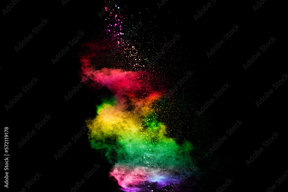Explosion of colorful Holi powder on black background. Vibrant color dust particles textured background.