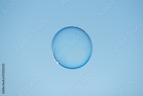Soap bubble floating against clear blue sky close-up view