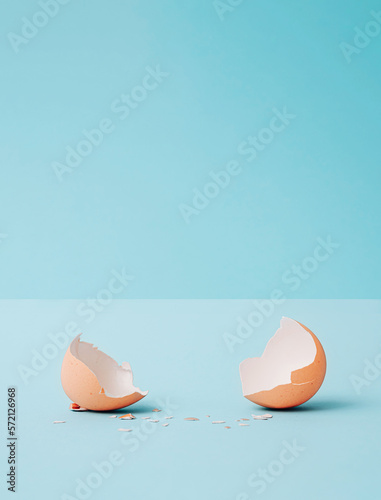 Minimal Abstract easter composition with egg broken eggshells and copy space . Modern collage on pastel blue background. Creative art minimal aesthetics