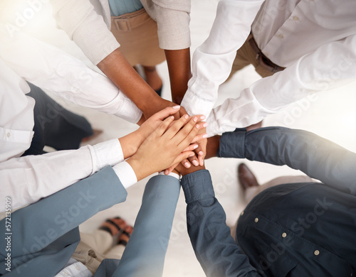 Team, diversity and stack of hands in the office for unity, celebration or support for solidarity. Collaboration, multiracial and top view of group of business people with motivation and in workplace