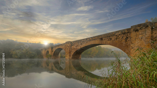 Puente medieval que cruza el rio Ebro a su paso por San Vicente de la Sonsierra, en la Rioja, España photo