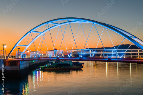 Fototapeta Naklejka Na Ścianę i Meble -  Pedestrian bridge across small seaport