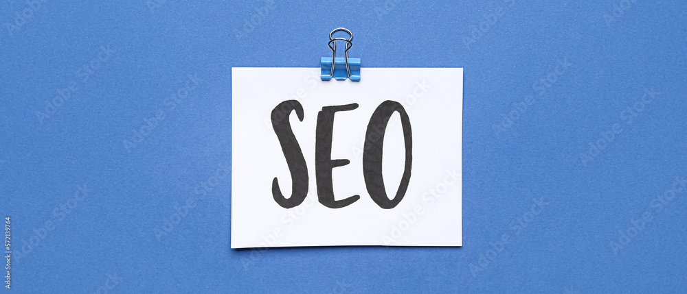 Paper sheet with abbreviation SEO on blue background Paper sheet with abbreviation SEO on blue background