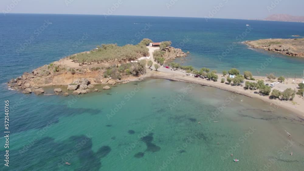 Aerial View Of Blue Ocean With Clear Water In Summer With Agii Apostoli Beach And Chapel of the Holy Apostles in Nea Kydonia, Chania, Greece.