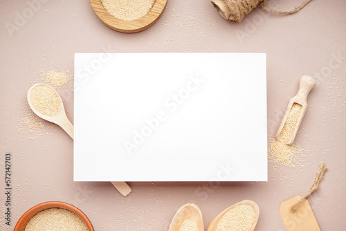 Composition with blank card and amaranth seeds on color background