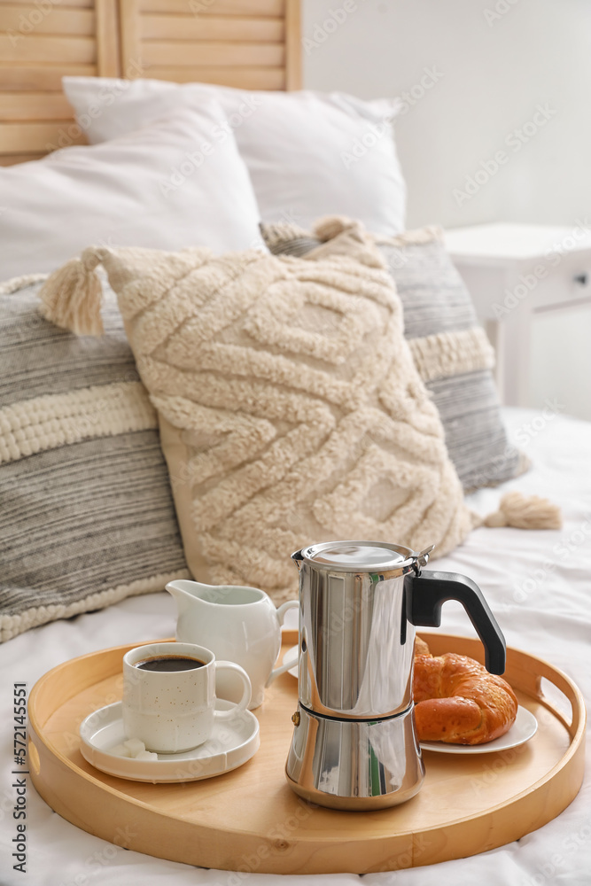 Tray with geyser coffee maker, cup of espresso and delicious croissant on bed Tray with geyser coffee maker, cup of espresso and delicious croissant on bed
