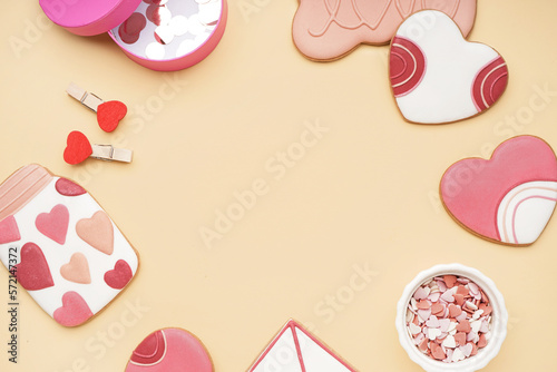 Frame made of sweet cookies, sprinkles and confetti on color background, closeup. Valentine's Day celebration