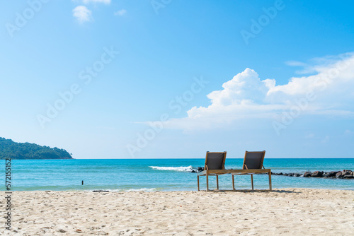 sun loungers chair on beautiful beach in Koh Kood island at Trat Thailand. blue sea and cloud on sky background © Jakkrit