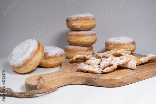 Polish pączki deep-fried doughnuts and angel wings sweet crisp pastry dough, sprinkled with powdered sugar. Popular in Poland during Carnival and Fat Thursday Tłusty czwartek feast day.