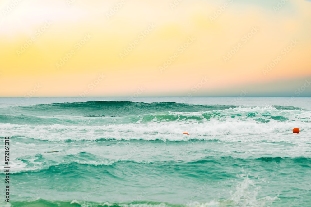 Tropical beach with blurred horizon at sunset, backdrop of sparkling ocean water. Natural seascape.