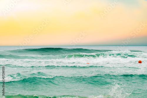 Tropical beach with blurred horizon at sunset, backdrop of sparkling ocean water. Natural seascape.
