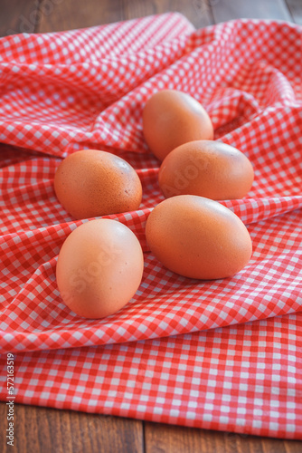 chicken eggs on pink classic tablecloth with selective focus