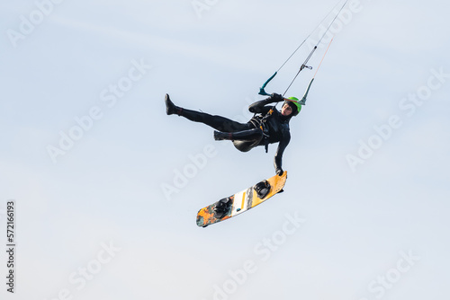 Kitesurfer jumping and making a board off trick in the air