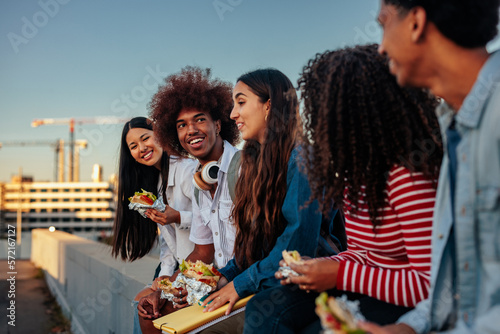 Tableau sur toile Multiethnic students have casual lunch outside.
