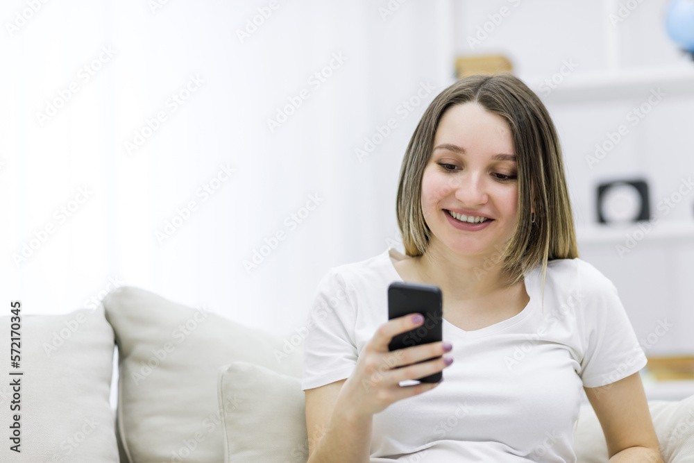 Close-up photo of beautiful pregnant woman looking at the phone. Close-up photo of beautiful pregnant woman looking at the phone.