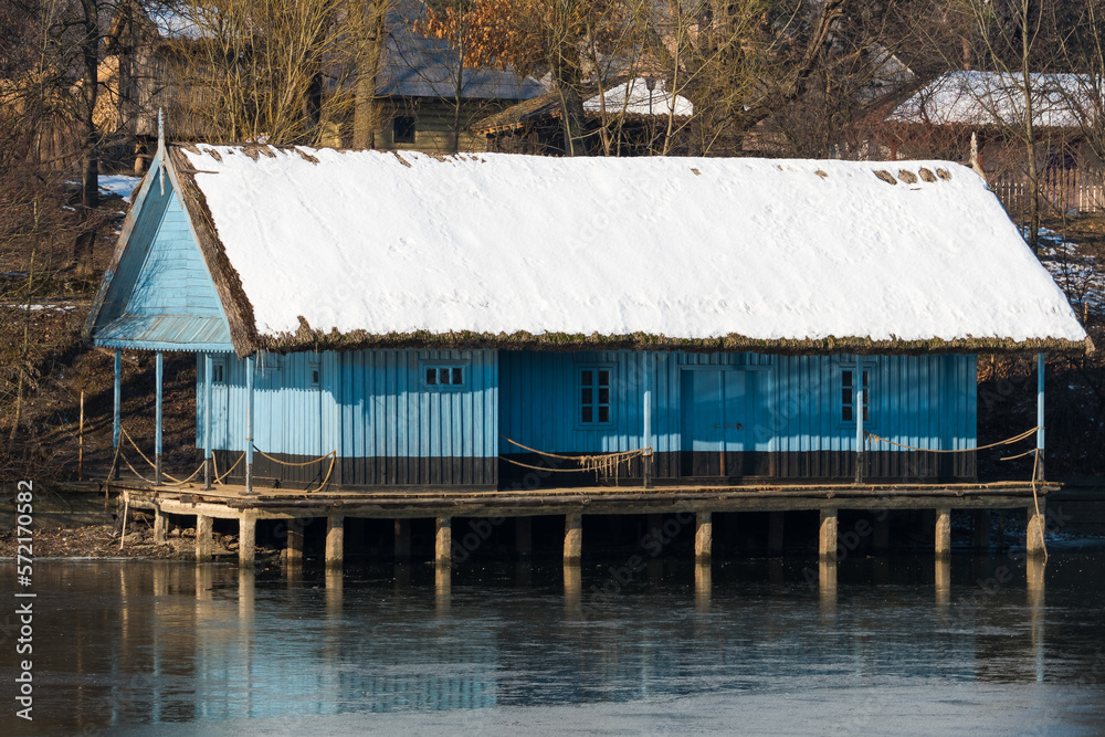 An Old Wooden Peasant House Covered by Snow is Being Beautifully Reflected onto the Lake Surface An Old Wooden Peasant House Covered by Snow is Being Beautifully Reflected onto the Lake Surface