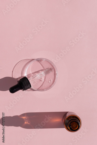 Hyaluronic acid serum or gel for the face with a pipette in Petri dish and a bottle on a pink background. Concept of cosmetics laboratory researches, wellness and beauty. © Marina Kaiser