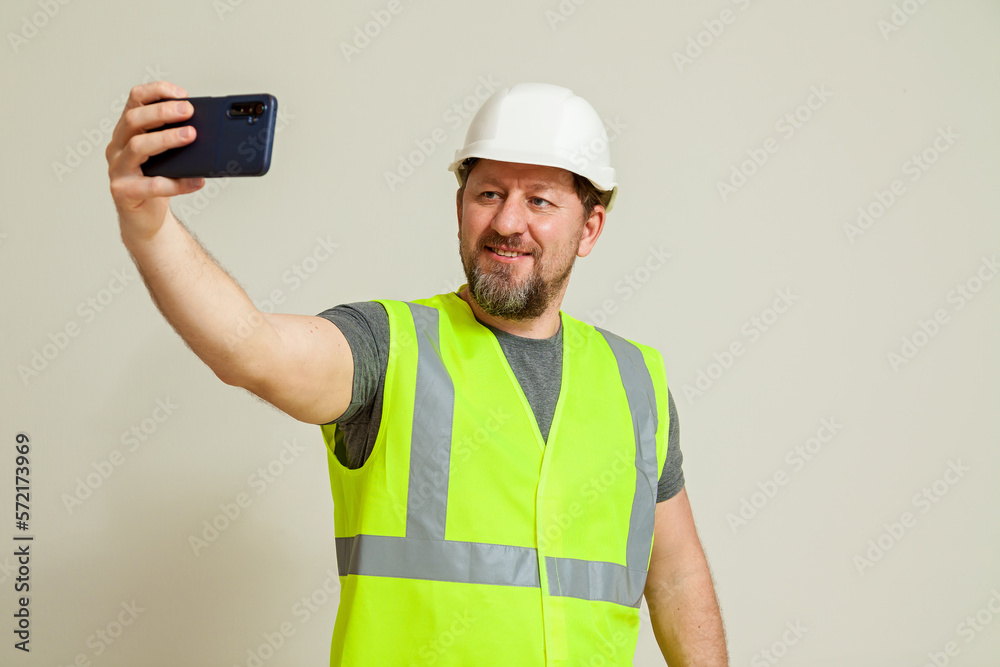 worker in a vest and white helmet worker in a vest and white helmet