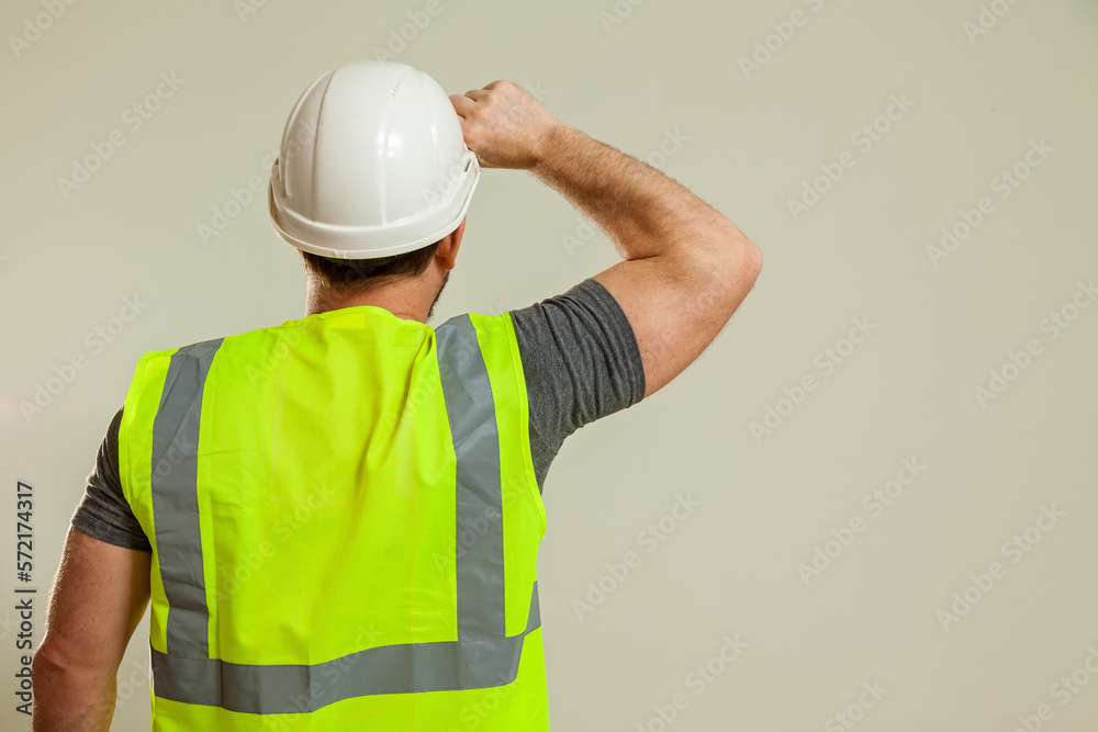 worker in a vest and white helmet worker in a vest and white helmet