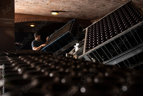 Man working in wine cellar of Cava production