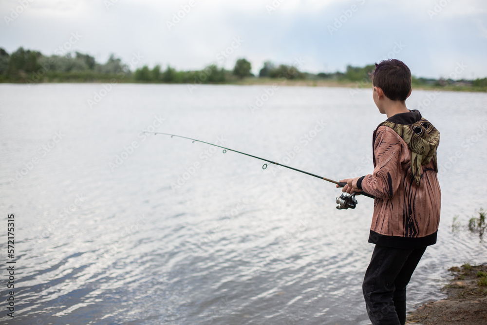Boy fishing in pond by himself Boy fishing in pond by himself