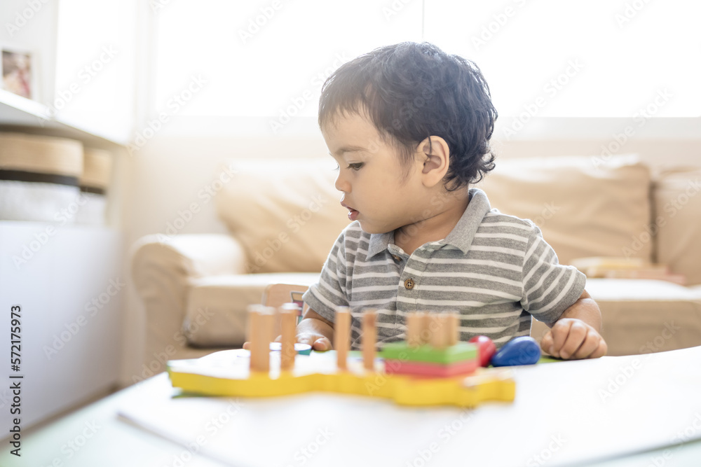 Child with educational logic toys in the living room Child with educational logic toys in the living room