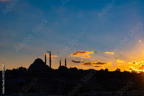 Istanbul silhouette at sunset. Suleymaniye Mosque and cloudy sky