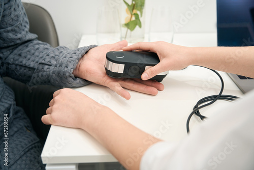 Unrecognized man is getting body examining with modern technology device