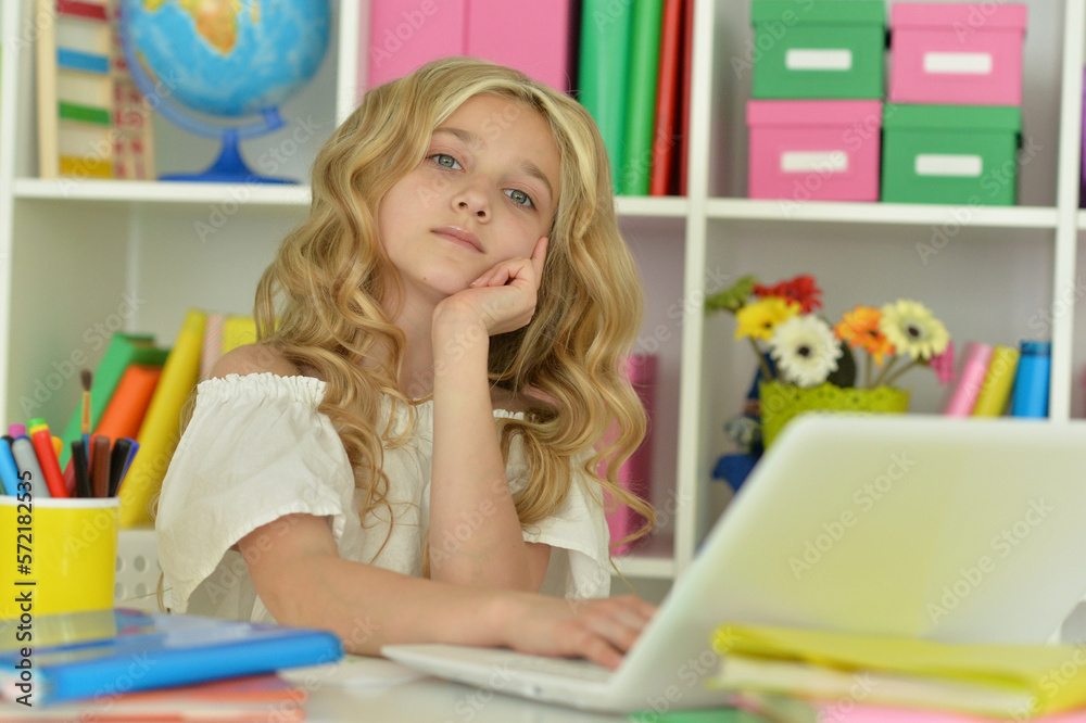 girl using laptop at desk at home girl using laptop at desk at home