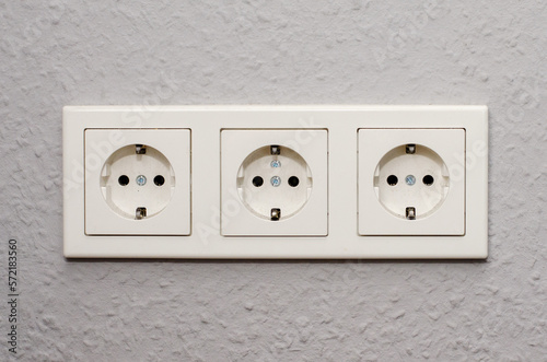 Three electrical outlets on the wall