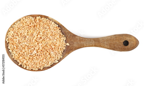 Chopped dry garlic pile in wooden spoon, isolated on white, top view