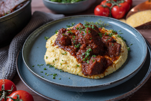 Pork ragout with creamy polenta on a plate