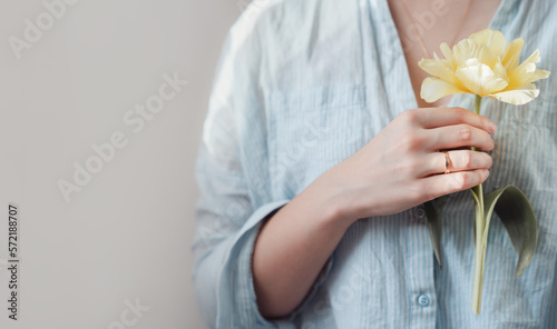 Woman holding tulip, spring lifestyle aesthetic, with copy space