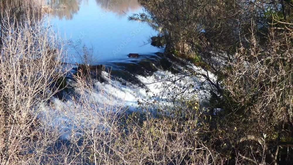 dam on a small river. Water flows from a small river dam. dam on a small river. Water flows from a small river dam.