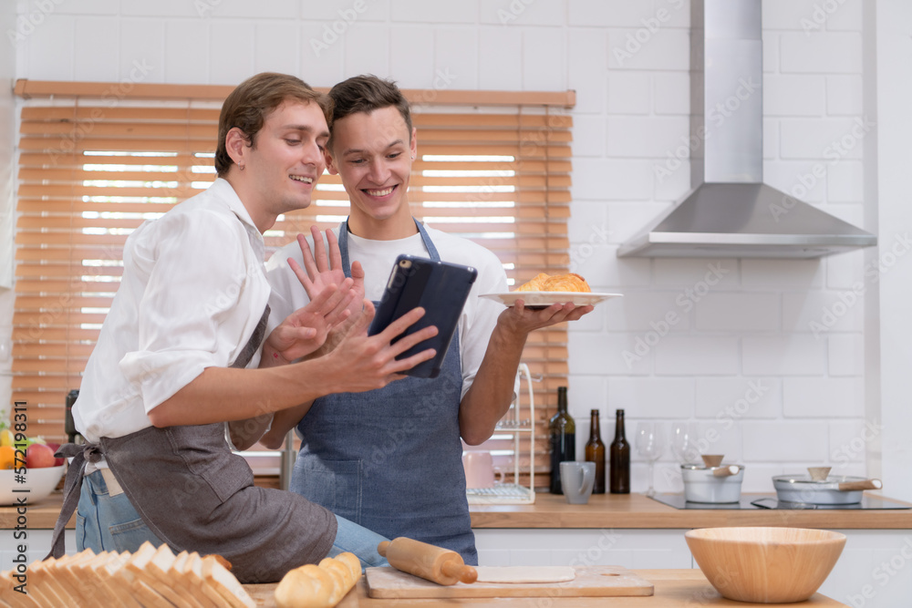 Young couple go to the kitchen and learn how to bake cookies online. Do it and play happily and have fun. Young couple go to the kitchen and learn how to bake cookies online. Do it and play happily and have fun.