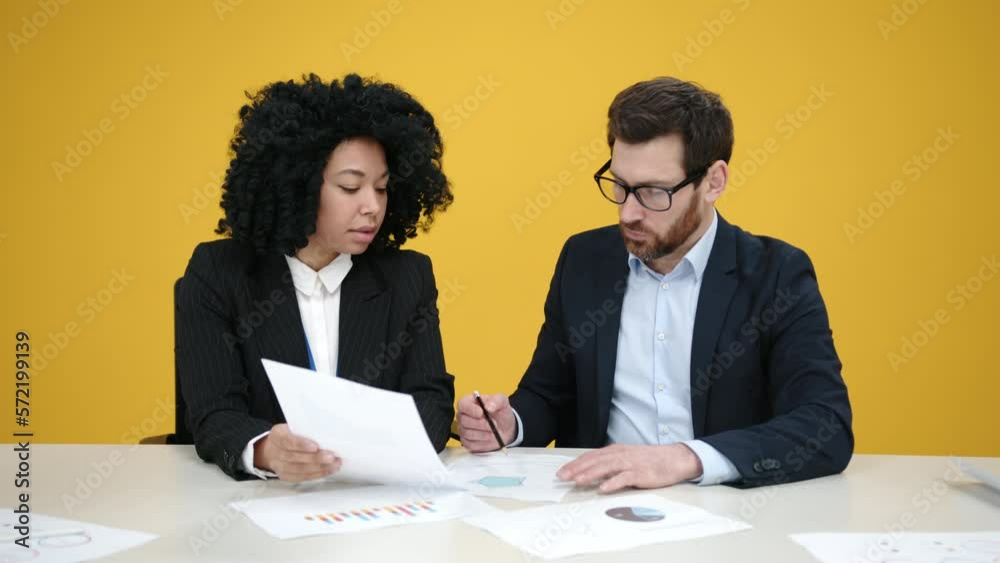 Portrait of young and skilled sales managers calculating annum revenue. Close-up view of professionals discussing new sales strategy indoors. High quality 4k footage Portrait of young and skilled sales managers calculating annum revenue. Close-up view of professionals discussing new sales strategy indoors. High quality 4k footage